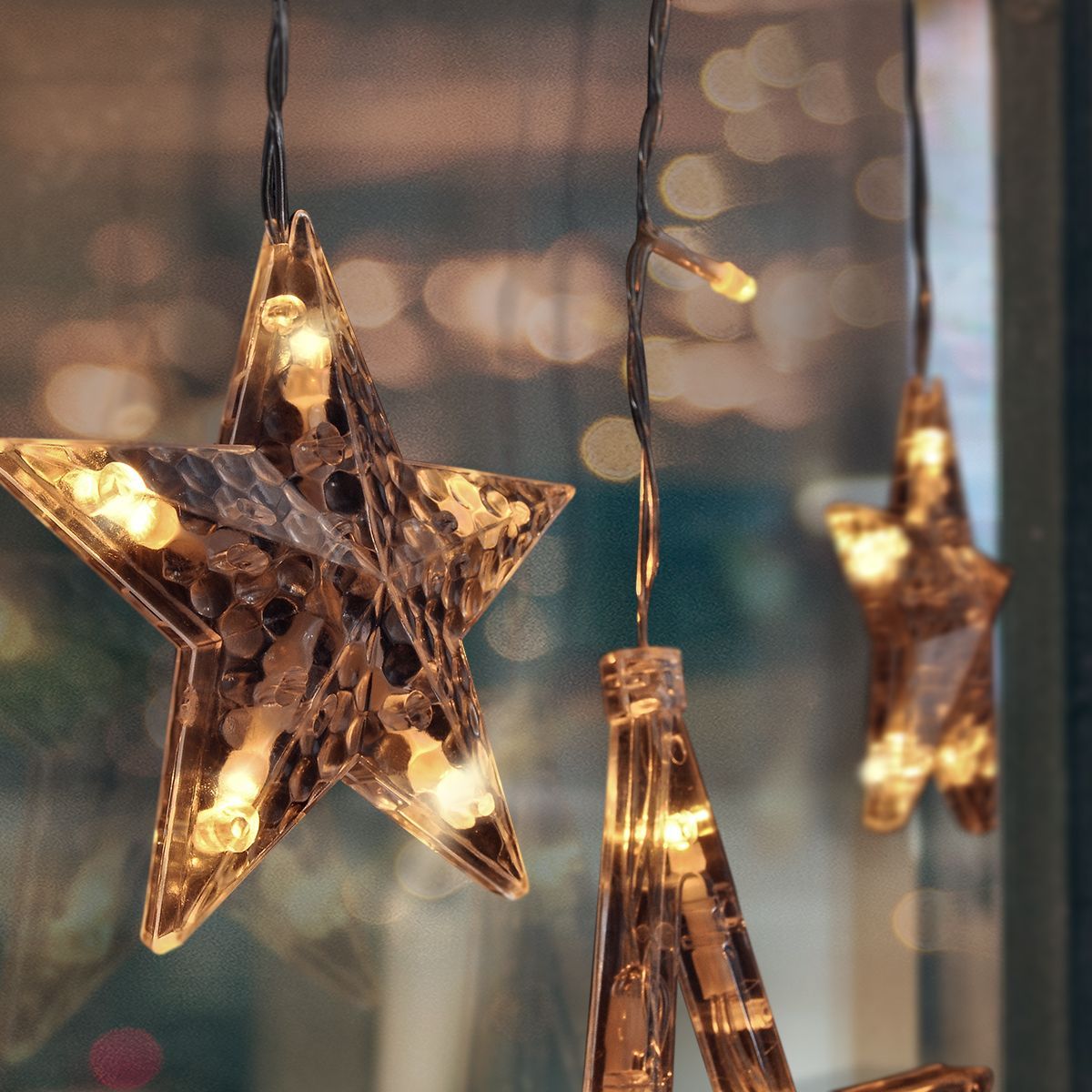 LED venkovní vánoční závěs, hvězdy, šíře 3 m, 123LED, IP44, 3 x AA, teplá bílá
